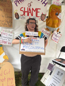 photoboothofshame_GE image of the photo booth of shame event with Gabe Evans in the booth of shame for lying to his constituents