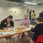 20251011_144049webp - Indivisible Denver People writing postcards