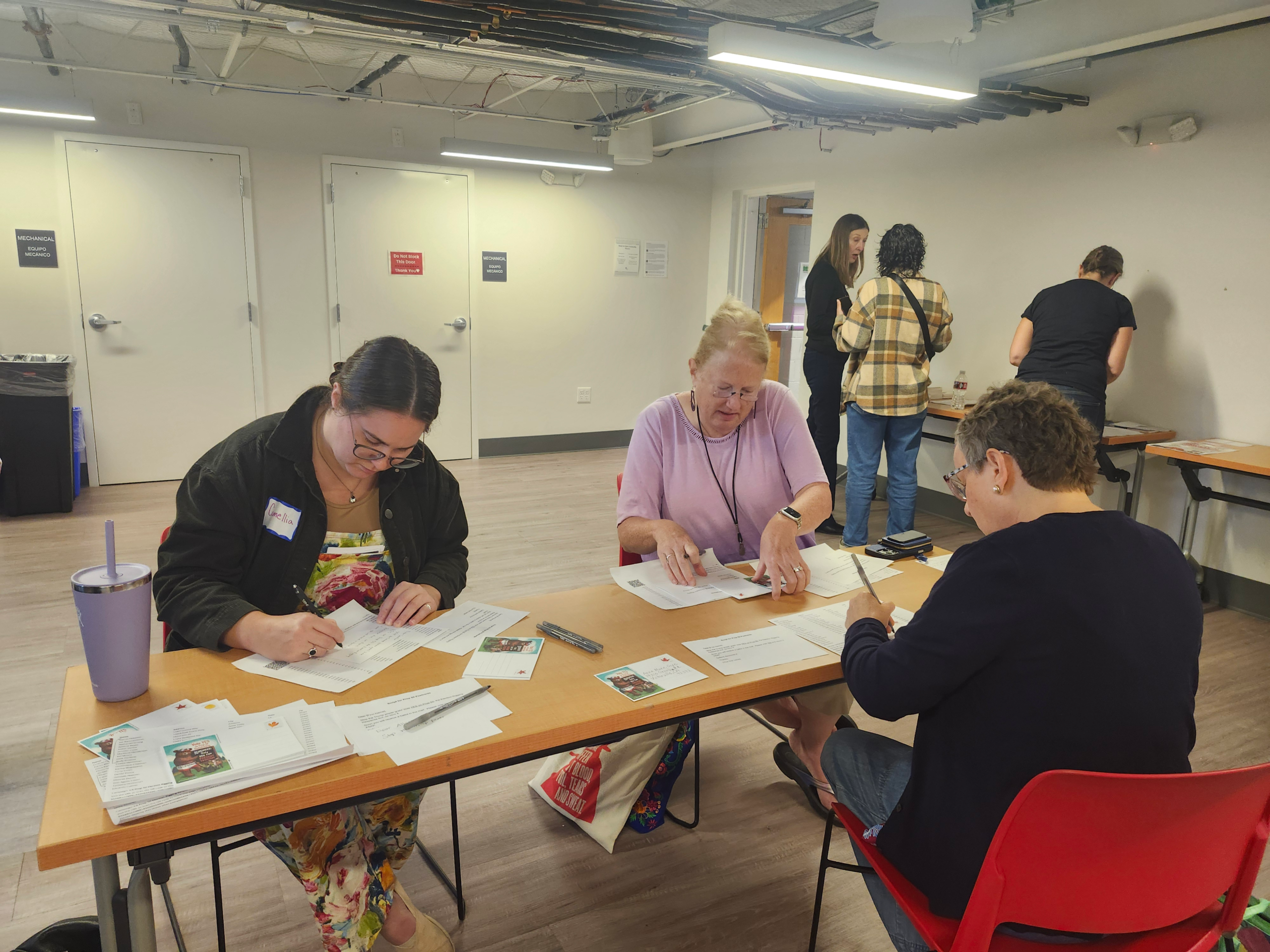 People writing postcards